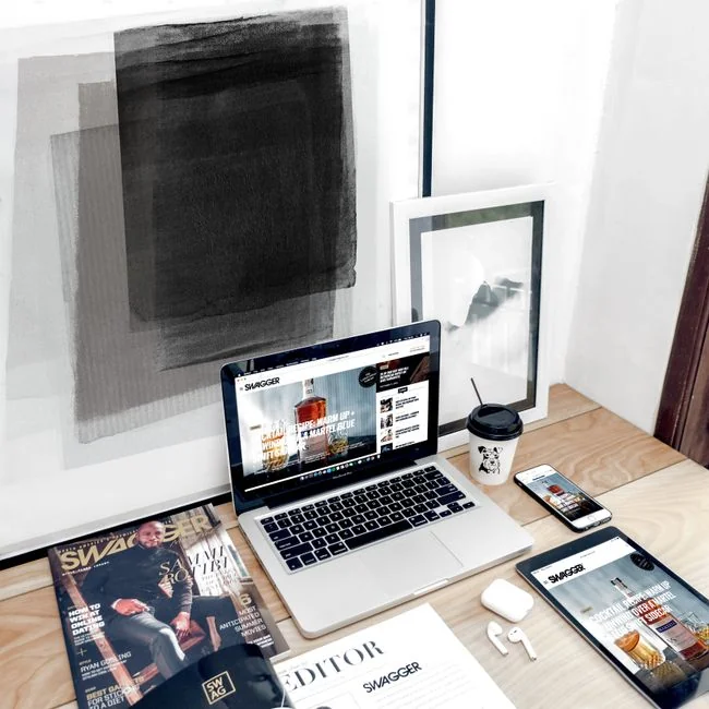 Dual monitors on a desk, showcasing web design in a modern office setting.