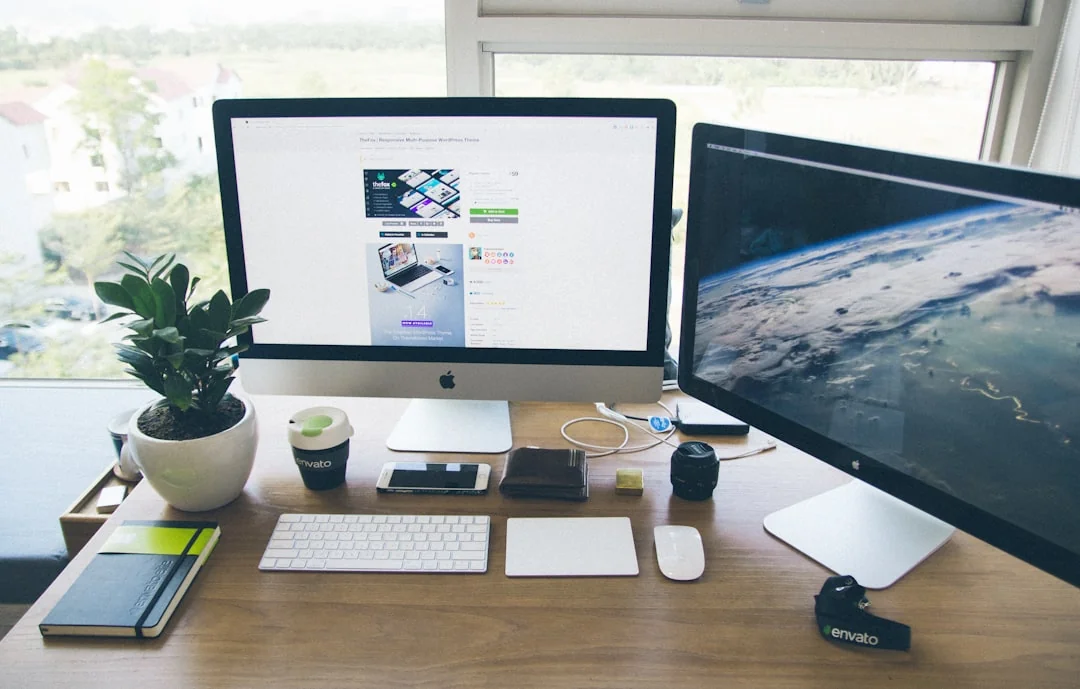 A contemporary workspace with two computer monitors showing web design projects, highlighting both technology and productivity.